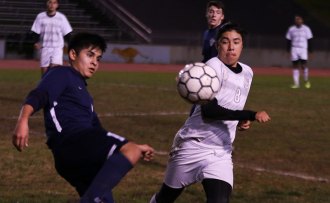 The Tigers' Diego Ceja has his eye on the ball in Redwood match.